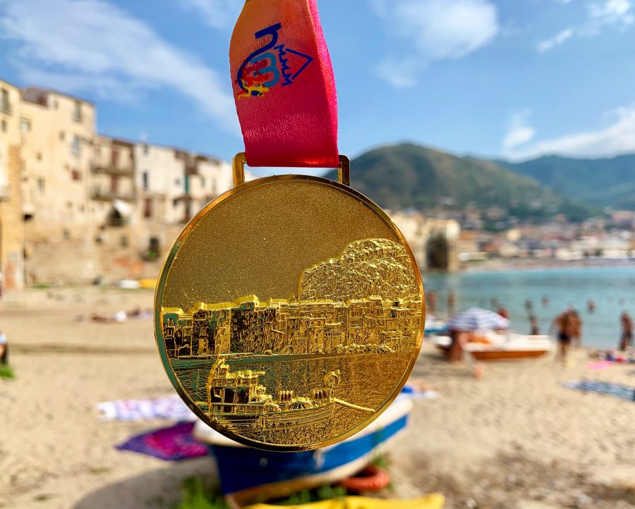 Half marathon medal in front of a beach